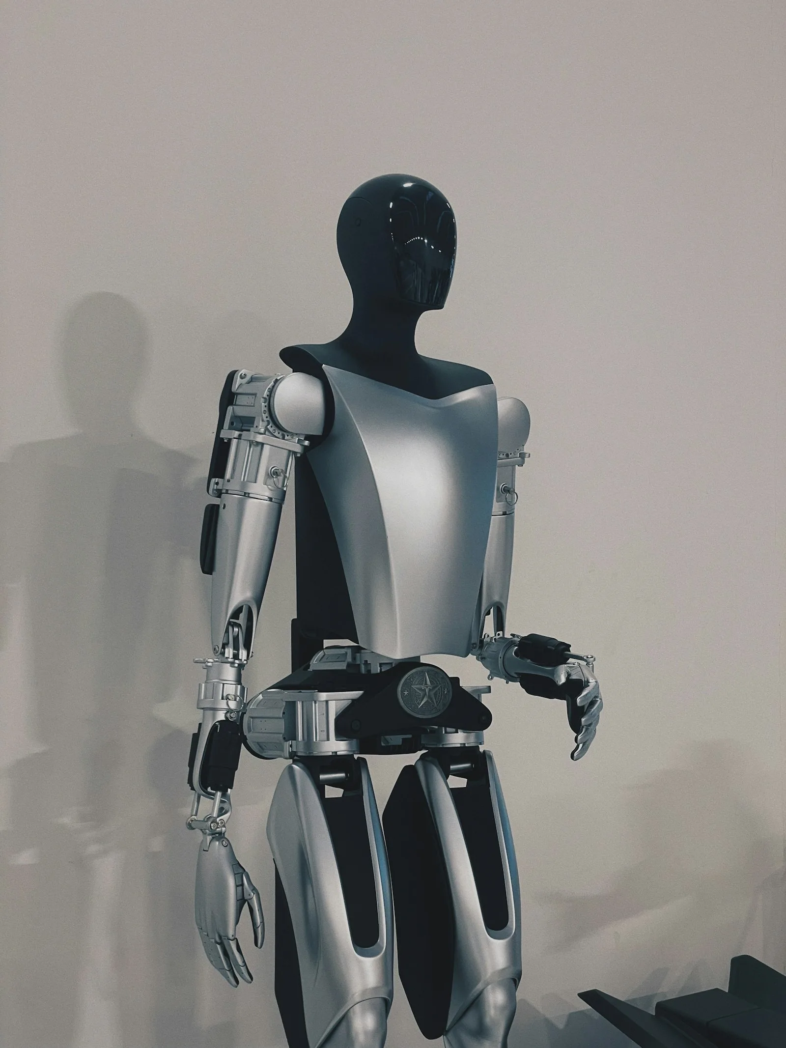 Robot standing in front of a plain white wall