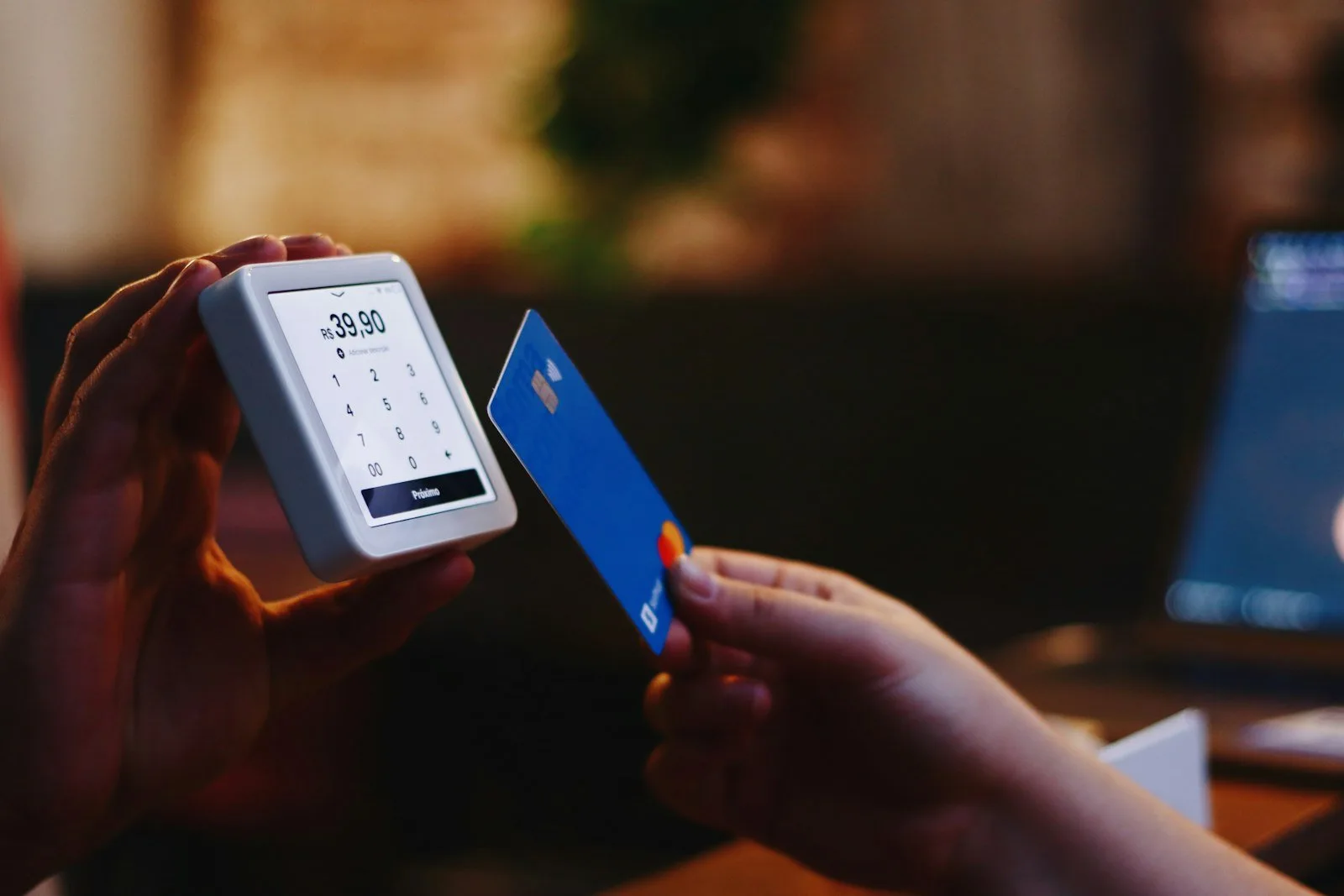 Person holding a credit card and a cell phone