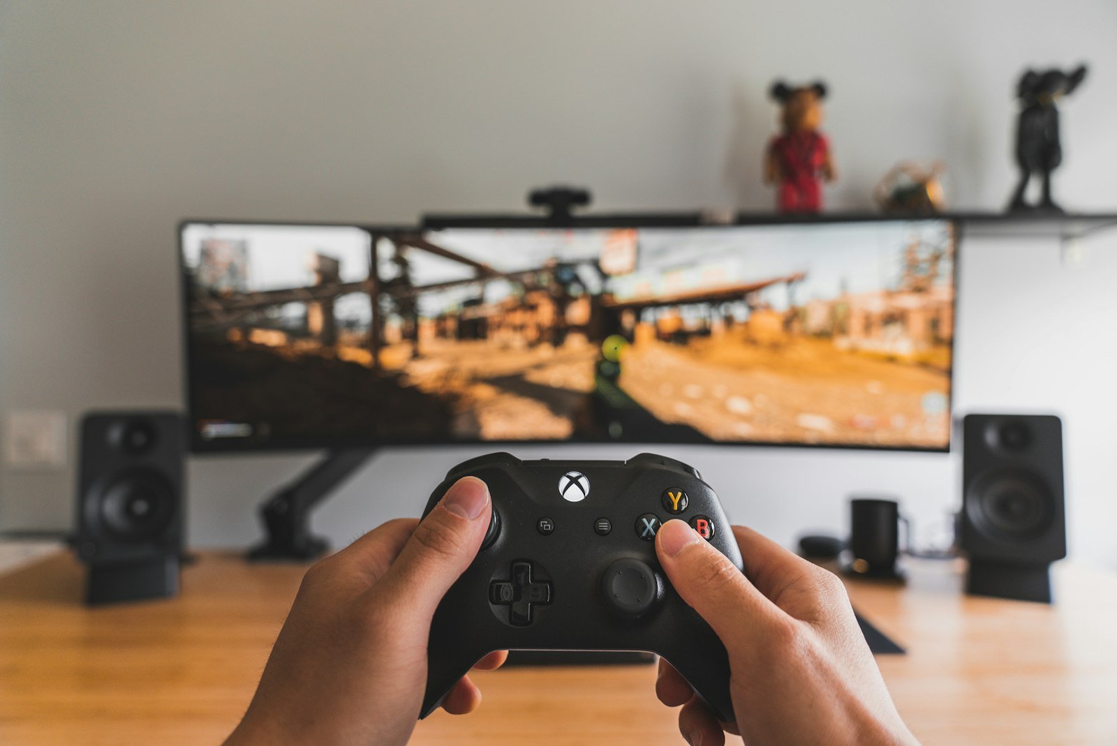 Person holding a black game controller